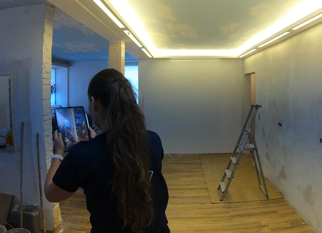 Person performing a 3D reality capture scan in a renovation construction site with MAVO 3D