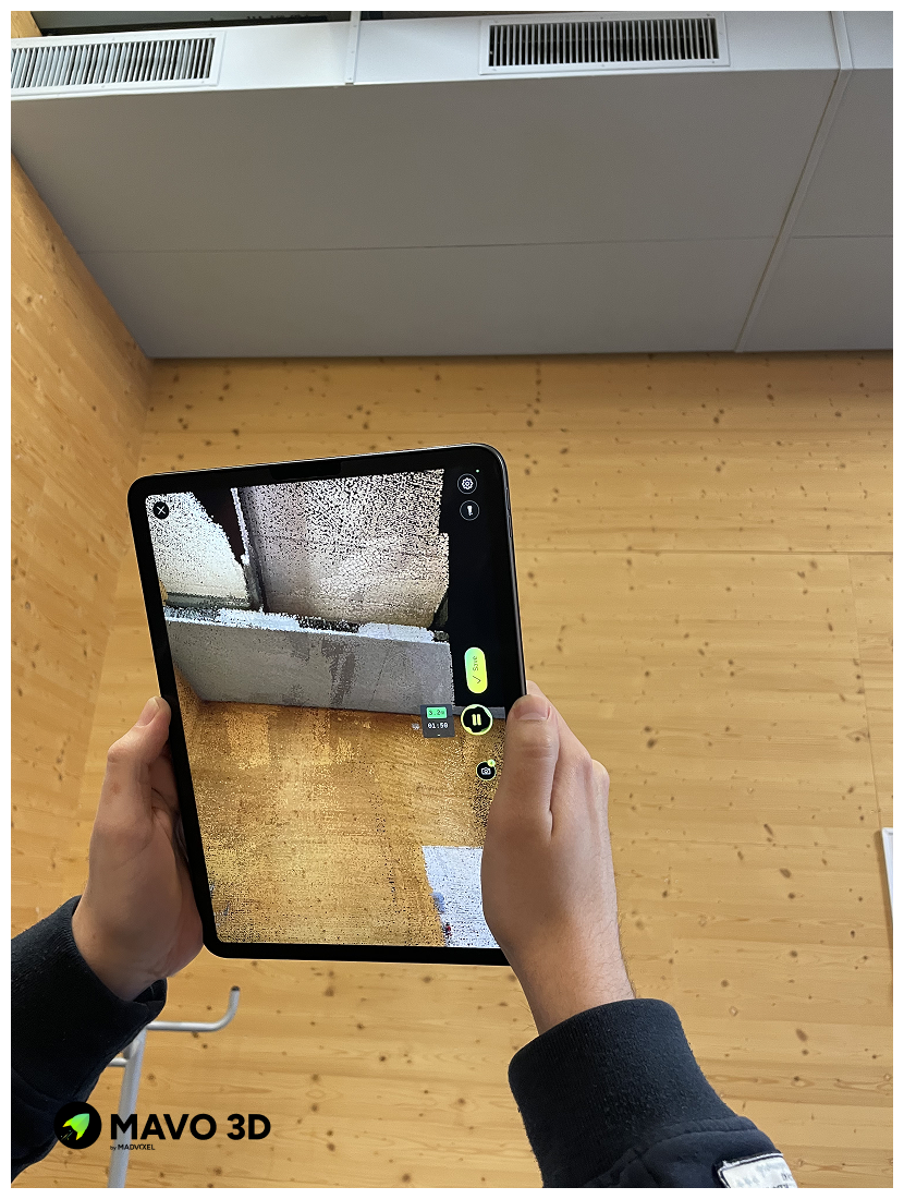 MAVO 3D app on iPad scanning the ceiling and upper walls of a room, capturing full 3D point cloud coverage